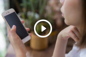 Woman holding a smartphone in a cafe — generic lifestyle stock photo