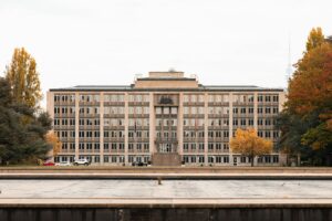 Historic government building in Canberra framed by autumn trees — Véurr Financial Planning specialist advice on Division 296 super tax, the $3M cap, CSS and PSS defined-benefit interaction, and Total Superannuation Balance planning