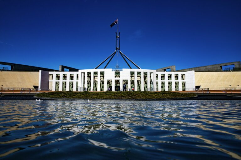 Australian Parliament House Canberra with national flag — Véurr Financial Planning specialist financial advice for federal public servants on CSS, PSS, and PSSap superannuation