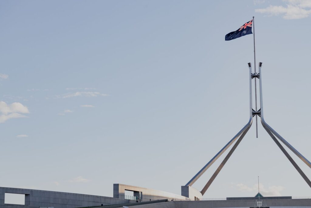 Australian Parliament House in Canberra under a clear blue sky with the national flag flying — featured image for Véurr Financial Planning guide on CSS 54-11 voluntary redundancy bridging strategy