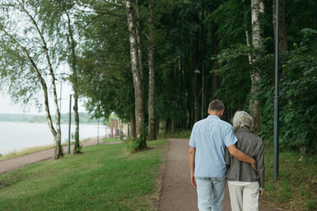 Older couple walking together on a tree-lined path, illustrating the transition-to-retirement stage that Véurr Financial Planning specialises in for Canberra pre-retirees.