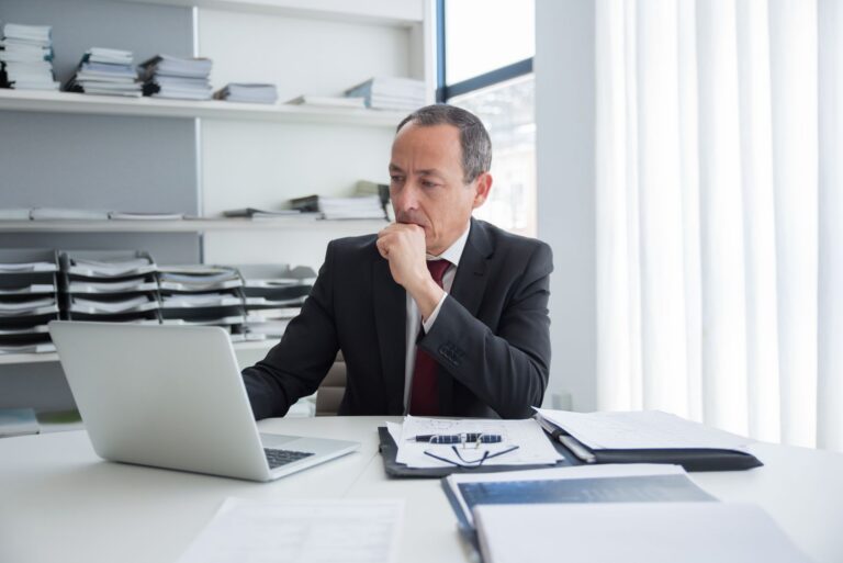 Public servant reviewing an ACT Government redundancy offer at an office desk.