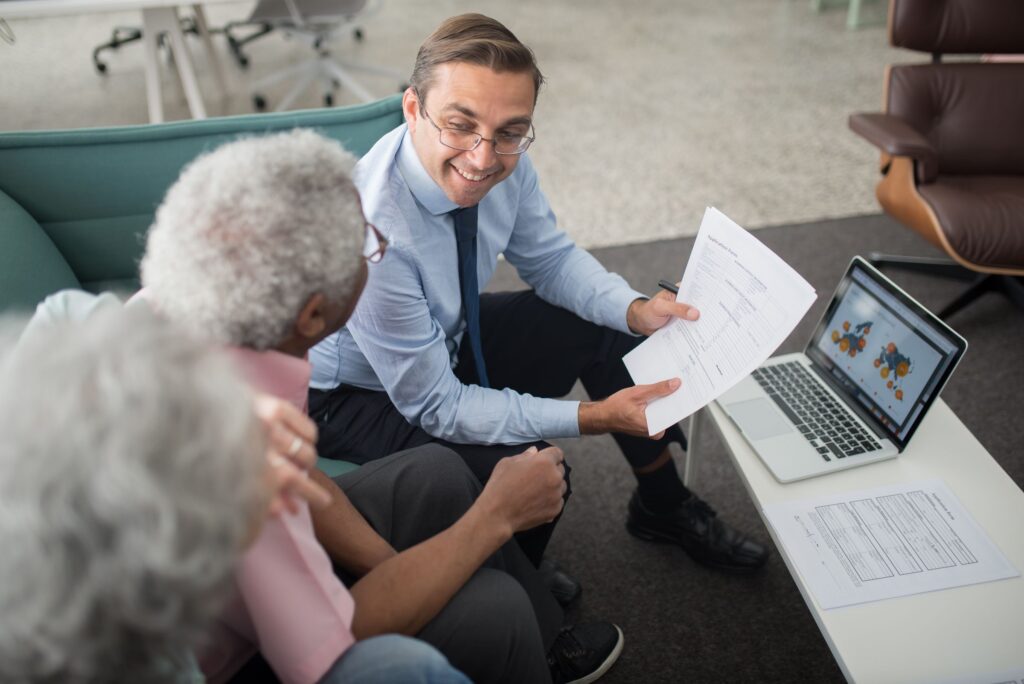 Financial adviser walking a couple through superannuation documents in a bright Canberra office.