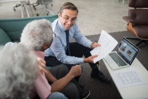 Financial adviser walking a couple through superannuation documents in a bright Canberra office.