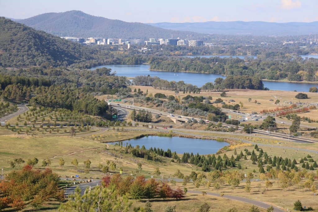 Aerial view across Canberra showing Lake Burley Griffin, bushland and the city centre in autumn