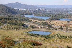 Aerial view across Canberra showing Lake Burley Griffin, bushland and the city centre in autumn